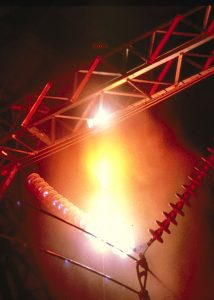 An image showcasing the experience of a power line with a red light on it.